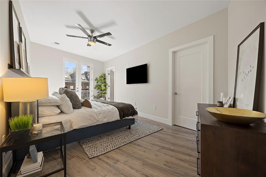 3725 Butler Street, Unit 302 Pittsburgh, PA 15201 - Photo 25 of 44 a bedroom with a bed and a flat screen tv