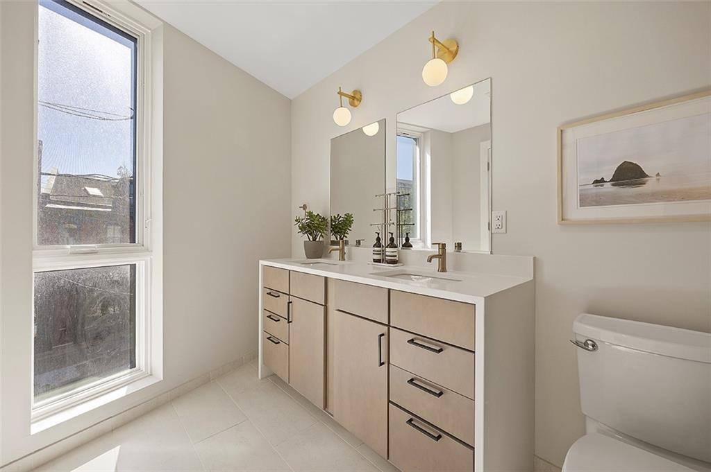 3725 Butler Street, Unit 302 Pittsburgh, PA 15201 - Photo 30 of 44 a bathroom with a sink a toilet and a mirror