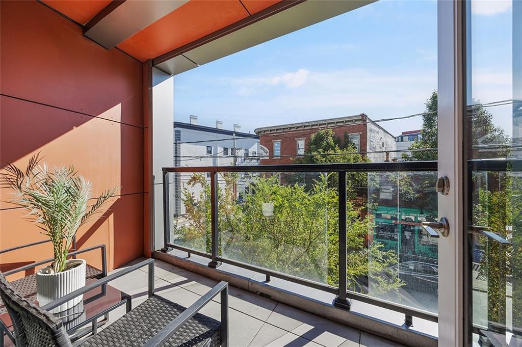 3725 Butler Street, Unit 302 Pittsburgh, PA 15201 - Photo 31 of 44 a view of a balcony with floor to ceiling windows with wooden floor