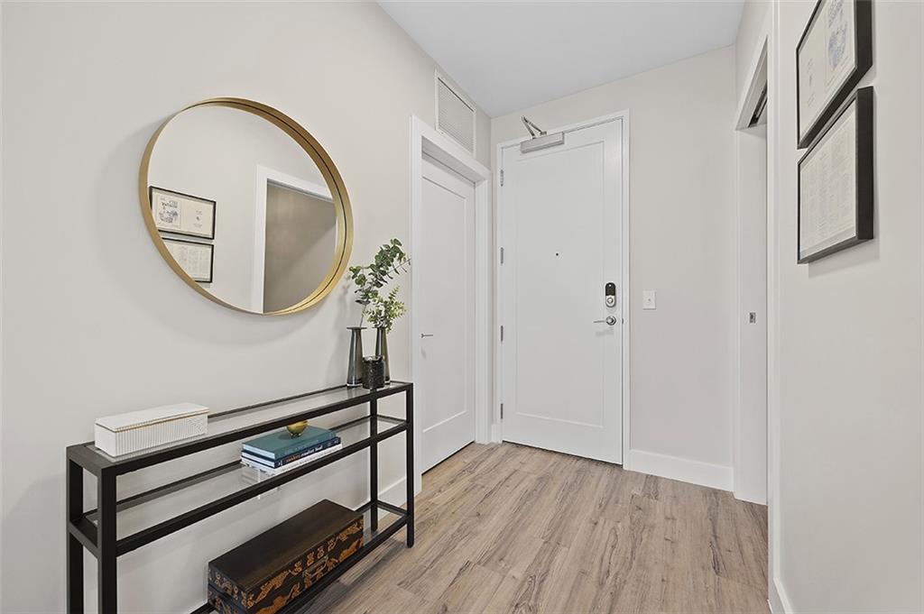 3725 Butler Street, Unit 302 Pittsburgh, PA 15201 - Photo 5 of 44 a view of a livingroom with wooden floor and a staircase