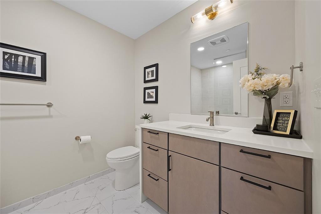 3725 Butler Street, Unit 302 Pittsburgh, PA 15201 - Photo 6 of 44 a bathroom with a toilet a sink and mirror