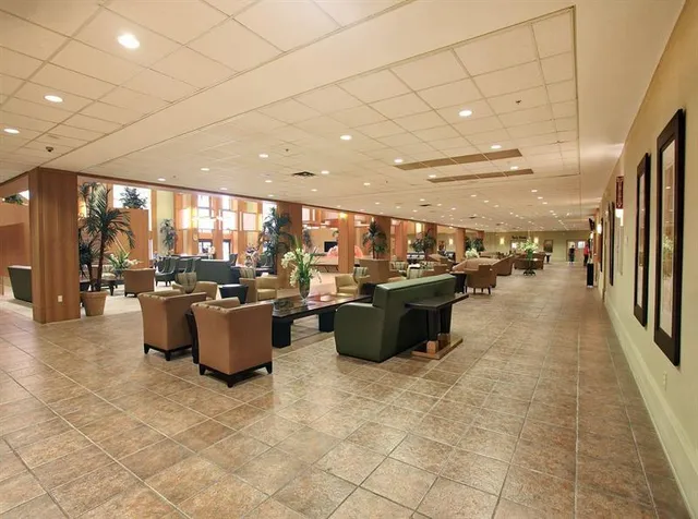 a view of living room with furniture and a floor to ceiling window