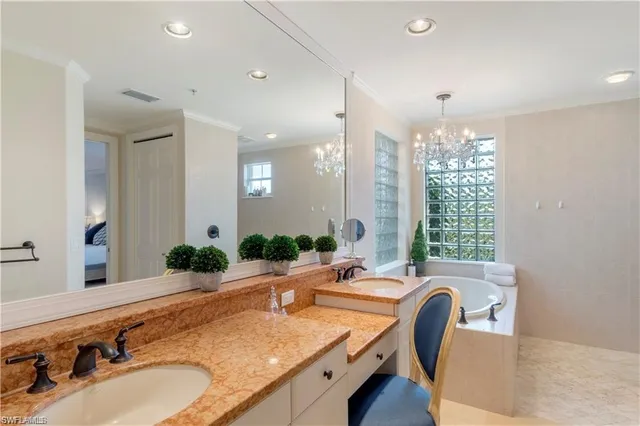 a bathroom with a granite countertop sink and a large mirror