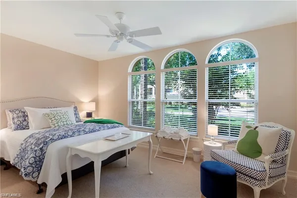 a bedroom with a bed and a balcony