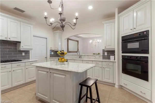 a kitchen with cabinets a sink and appliances