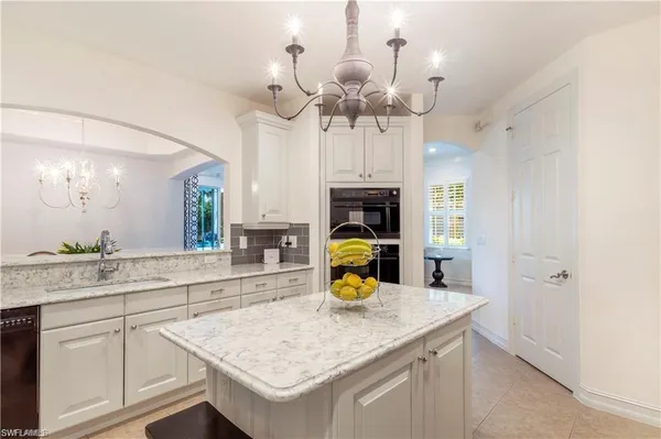 a kitchen with a sink a counter space and stainless steel appliances
