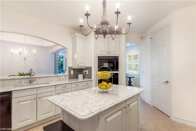a kitchen with a sink a counter space and stainless steel appliances