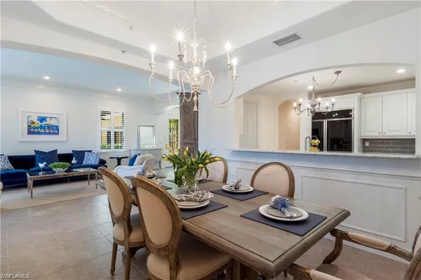 a dining room with furniture and chandelier