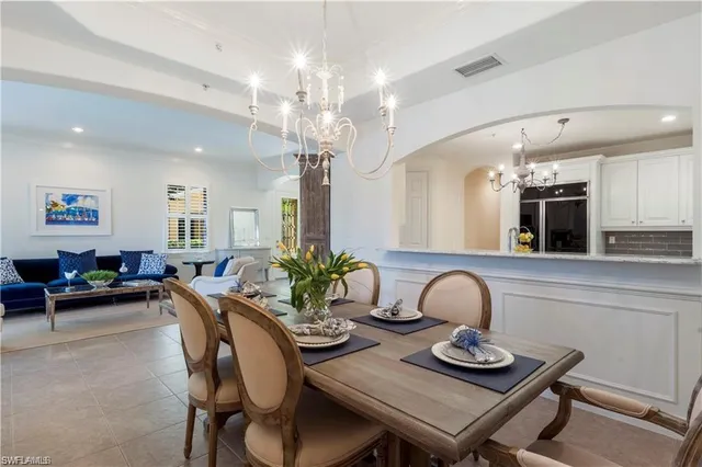 a dining room with furniture and chandelier
