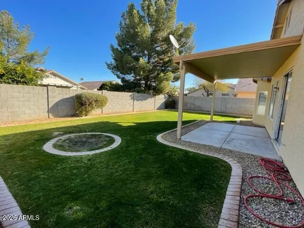 a view of a backyard with a slide and potted plants