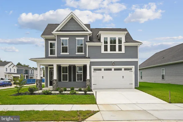a view of a big house with a big yard and large trees