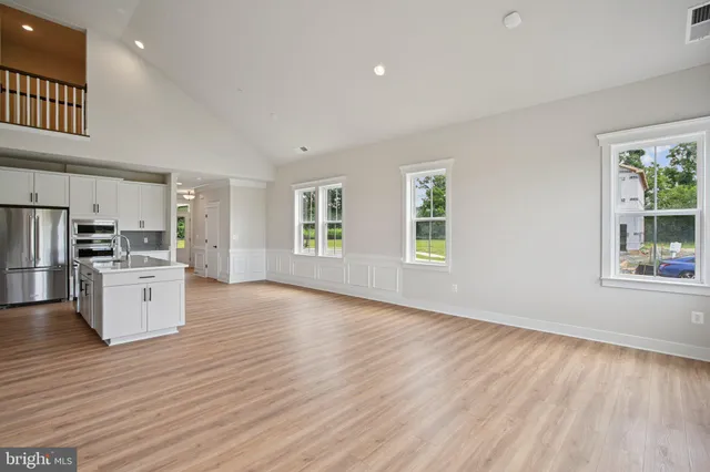 a view of a kitchen with microwave and refrigerator