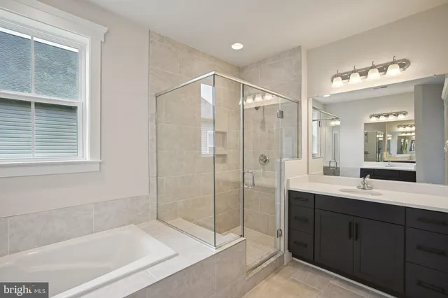 a bathroom with a shower sink and mirror