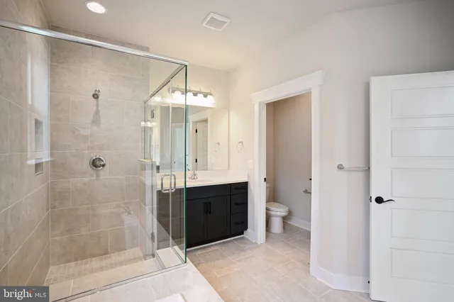 a bathroom with a shower and a toilet