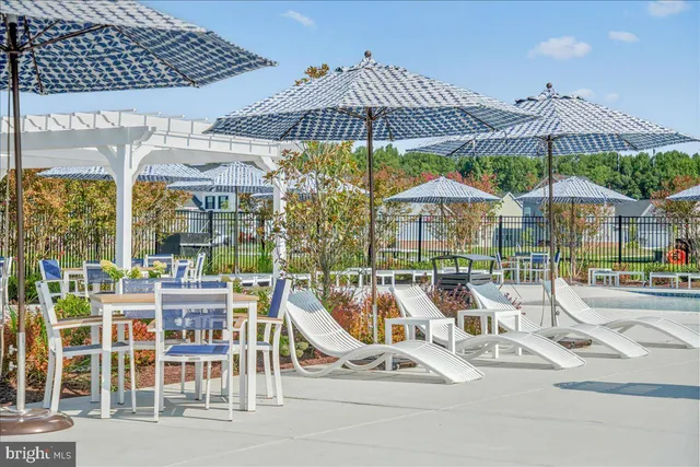 a view of a patio with a table and chairs under an umbrella