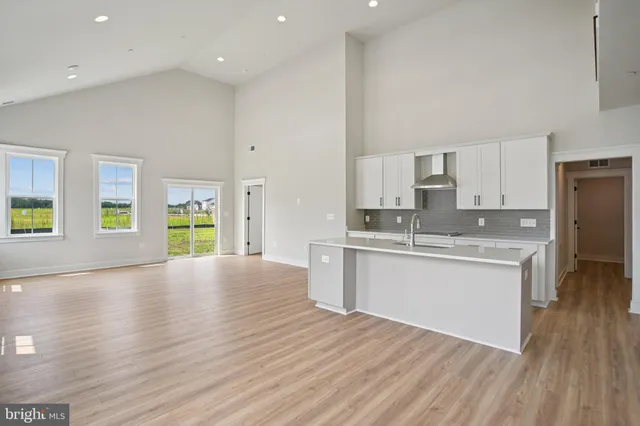 a large kitchen with stainless steel appliances granite countertop a granite counter tops and a wooden floors