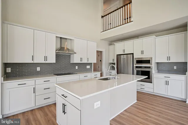 a kitchen with white cabinets sink and white appliances