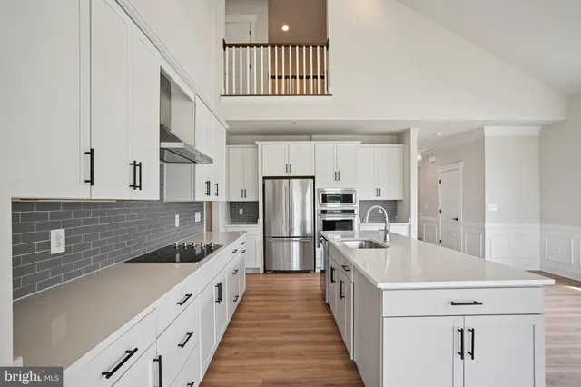 a kitchen with refrigerator a stove and a sink