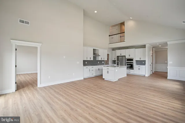 a view of a kitchen with wooden floor and electronic appliances