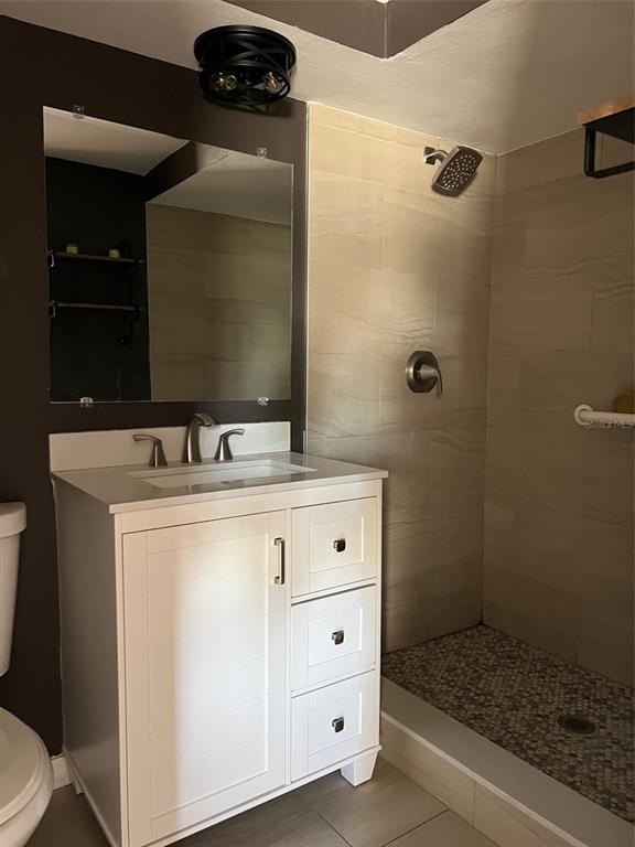 7835 Arbordale Drive Port Richey, FL 34668 - Photo 13 of 21 a bathroom with a sink a toilet and shower