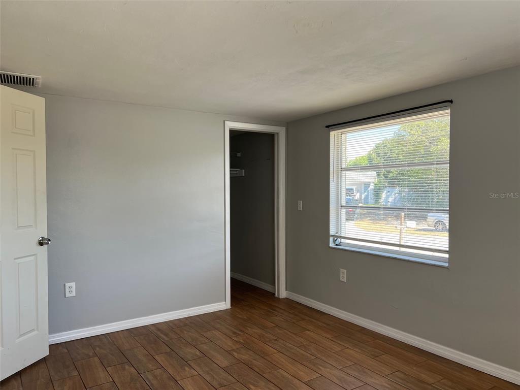 7835 Arbordale Drive Port Richey, FL 34668 - Photo 17 of 21 a view of an empty room with wooden floor and a window