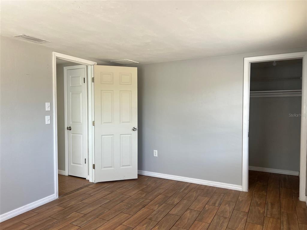 7835 Arbordale Drive Port Richey, FL 34668 - Photo 18 of 21 a view of an empty room with wooden floor