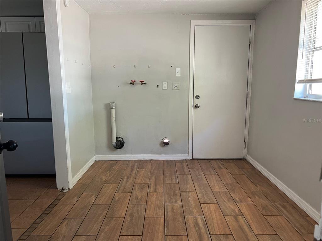 7835 Arbordale Drive Port Richey, FL 34668 - Photo 2 of 21 a view of an empty room with wooden floor and a window