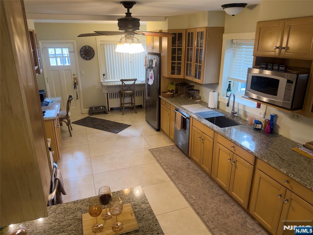 585 Monroe Place Ridgefield, NJ 07657 - Photo 9 of 28 a kitchen with stainless steel appliances a sink stove and refrigerator