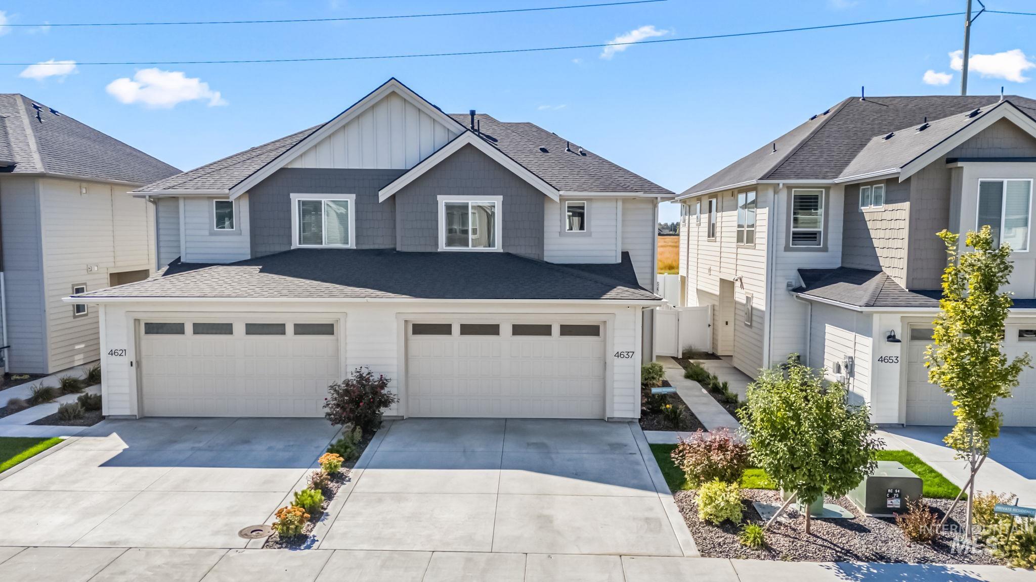 Craftsman inspired home with a shingled roof, concrete driveway, an attached garage, and board and batten siding