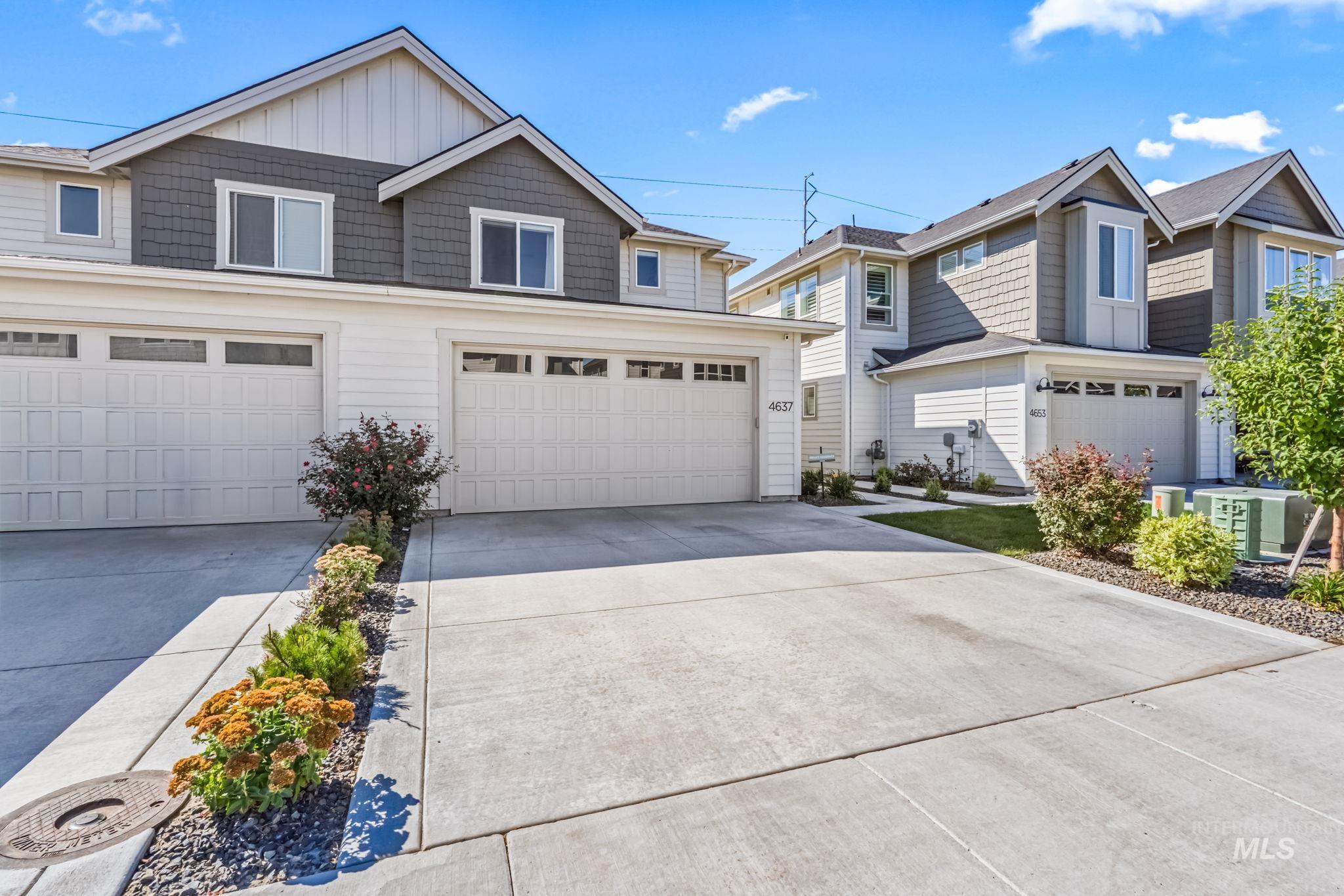 4637 West Riva Capri Street Meridian, ID 83646 - Photo 3 of 48 View of front facade featuring driveway, board and batten siding, and an attached garage
