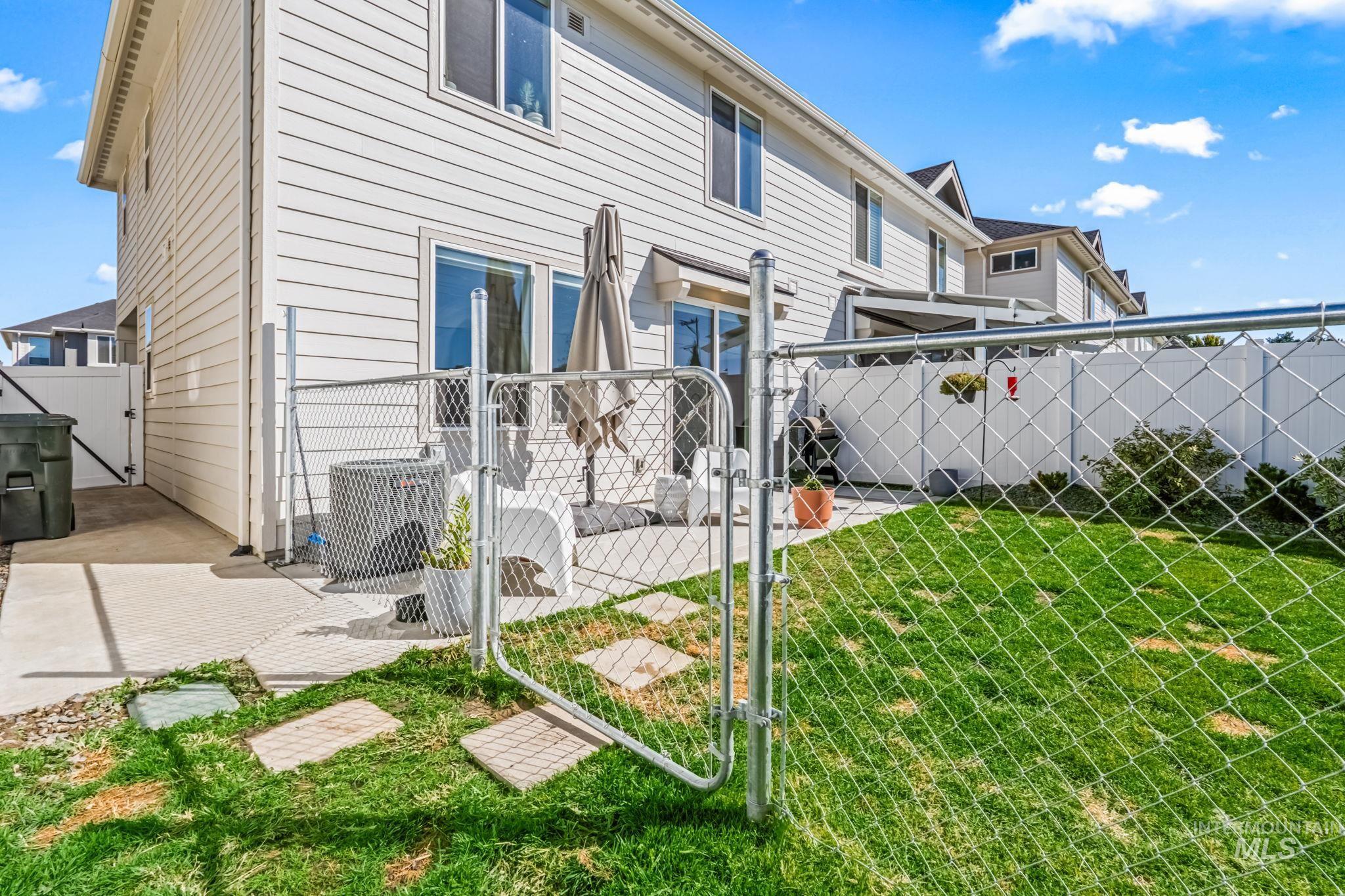 4637 West Riva Capri Street Meridian, ID 83646 - Photo 36 of 48 Back of house with a fenced backyard and a gate