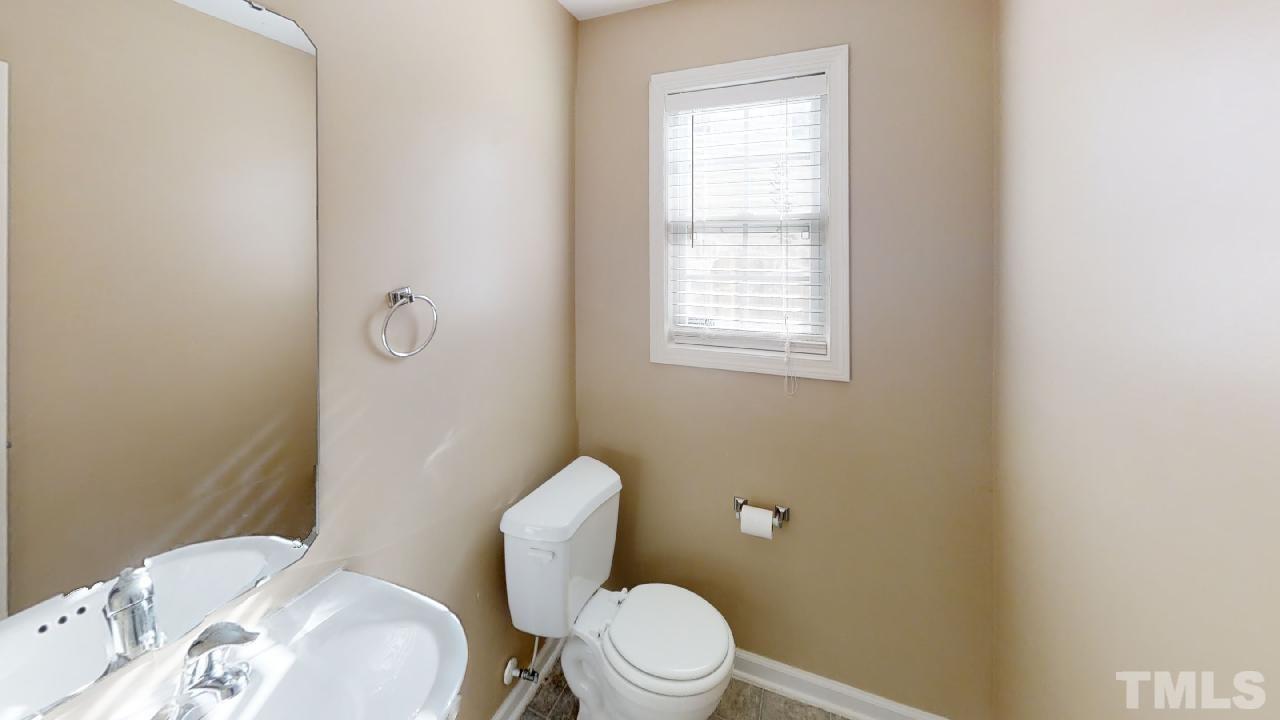 3636 Rendition Street Raleigh, NC 27610 - Photo 22 of 25 a white toilet sitting next to a bathroom sink