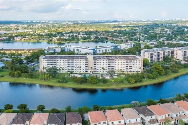 an aerial view of residential building with outdoor space and lake view