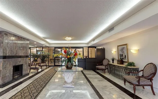 a dining room with furniture a chandelier and wooden floor