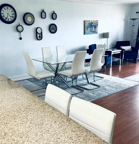 a view of a dining room with furniture and wooden floor