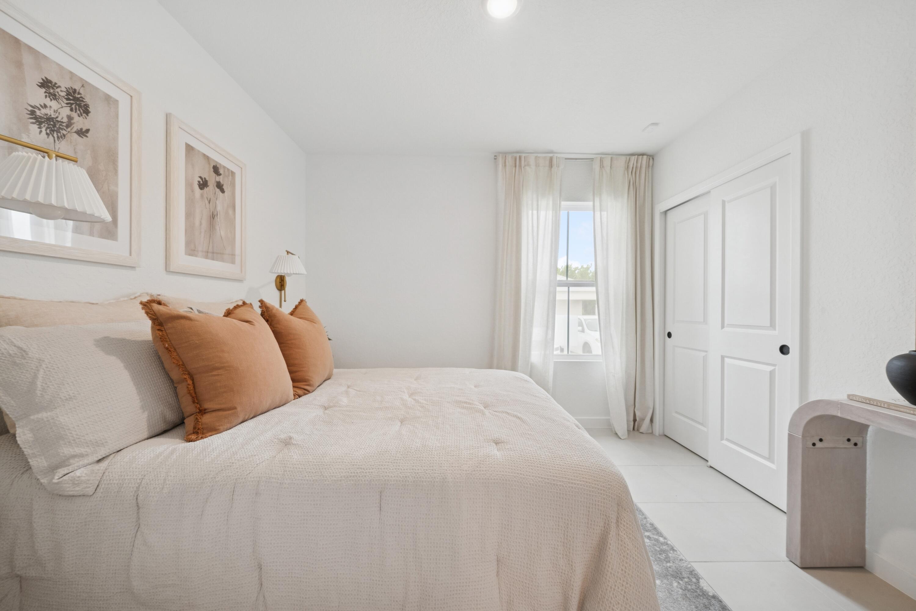 9744 Apollo Avenue, Unit 1 Fort Pierce, FL 34945 - Photo 12 of 39 a bedroom with bed a closet and large window