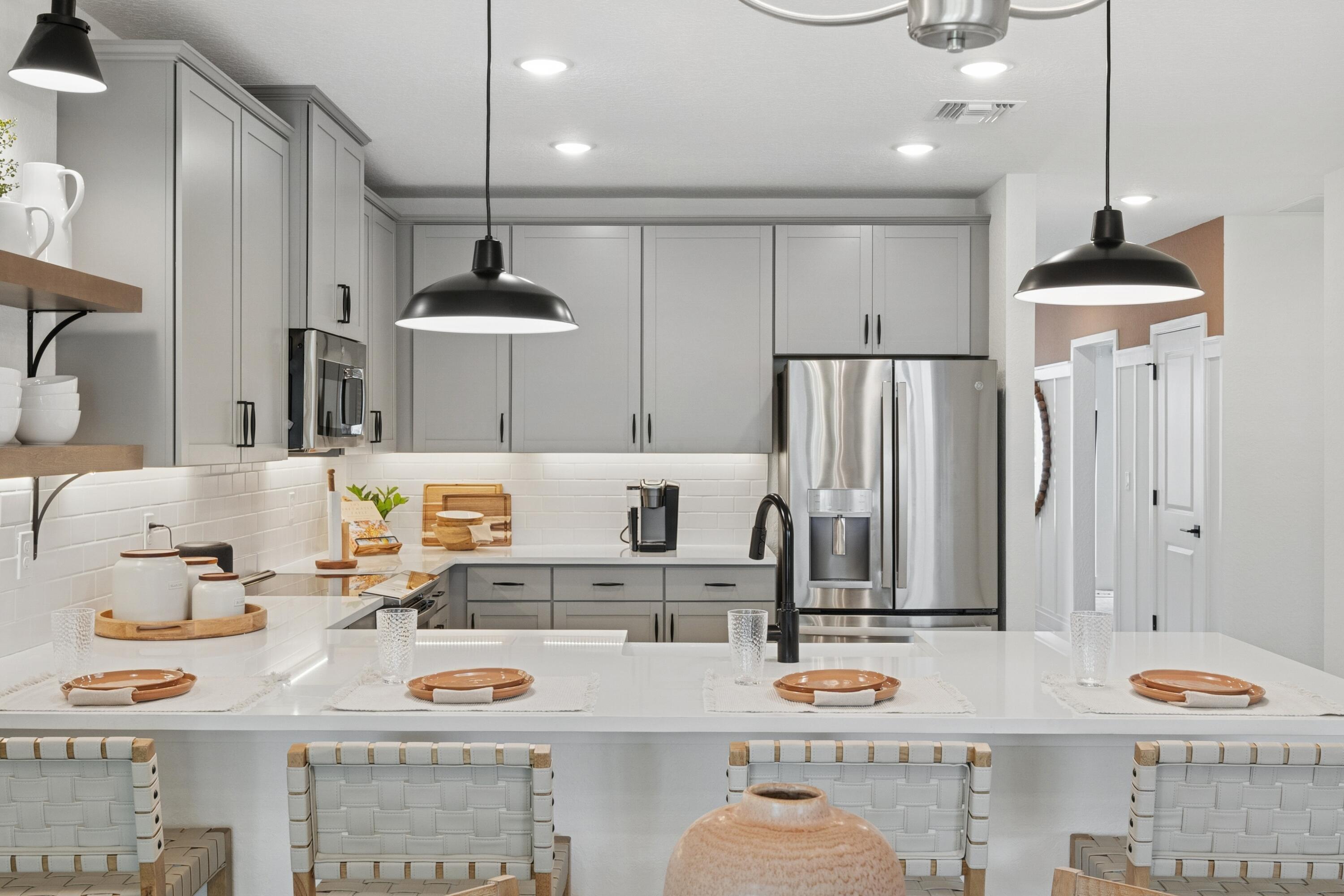 9744 Apollo Avenue, Unit 1 Fort Pierce, FL 34945 - Photo 16 of 39 a kitchen with stainless steel appliances kitchen island granite countertop a dining table and chairs