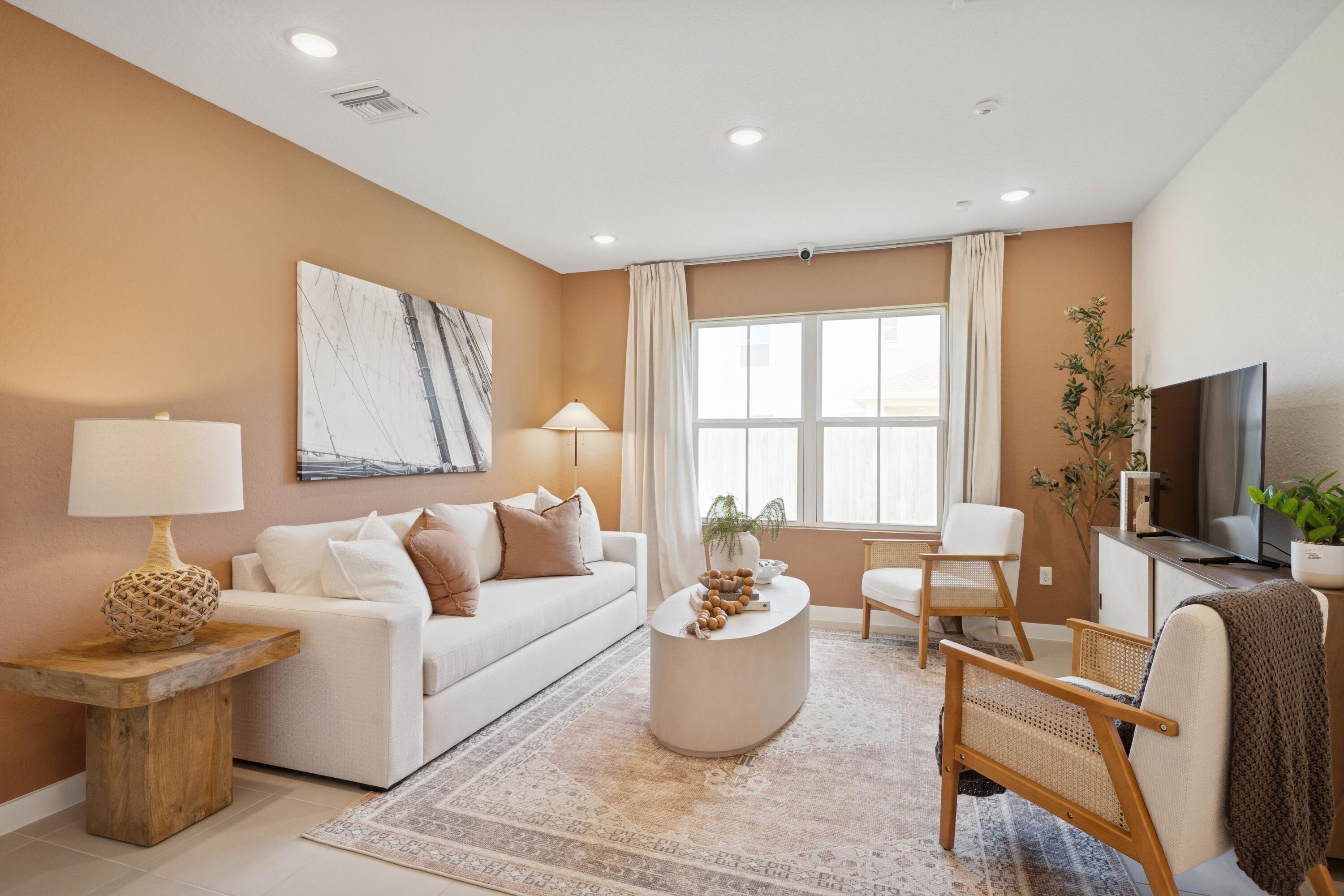 9744 Apollo Avenue, Unit 1 Fort Pierce, FL 34945 - Photo 26 of 39 a living room with furniture and a flat screen tv