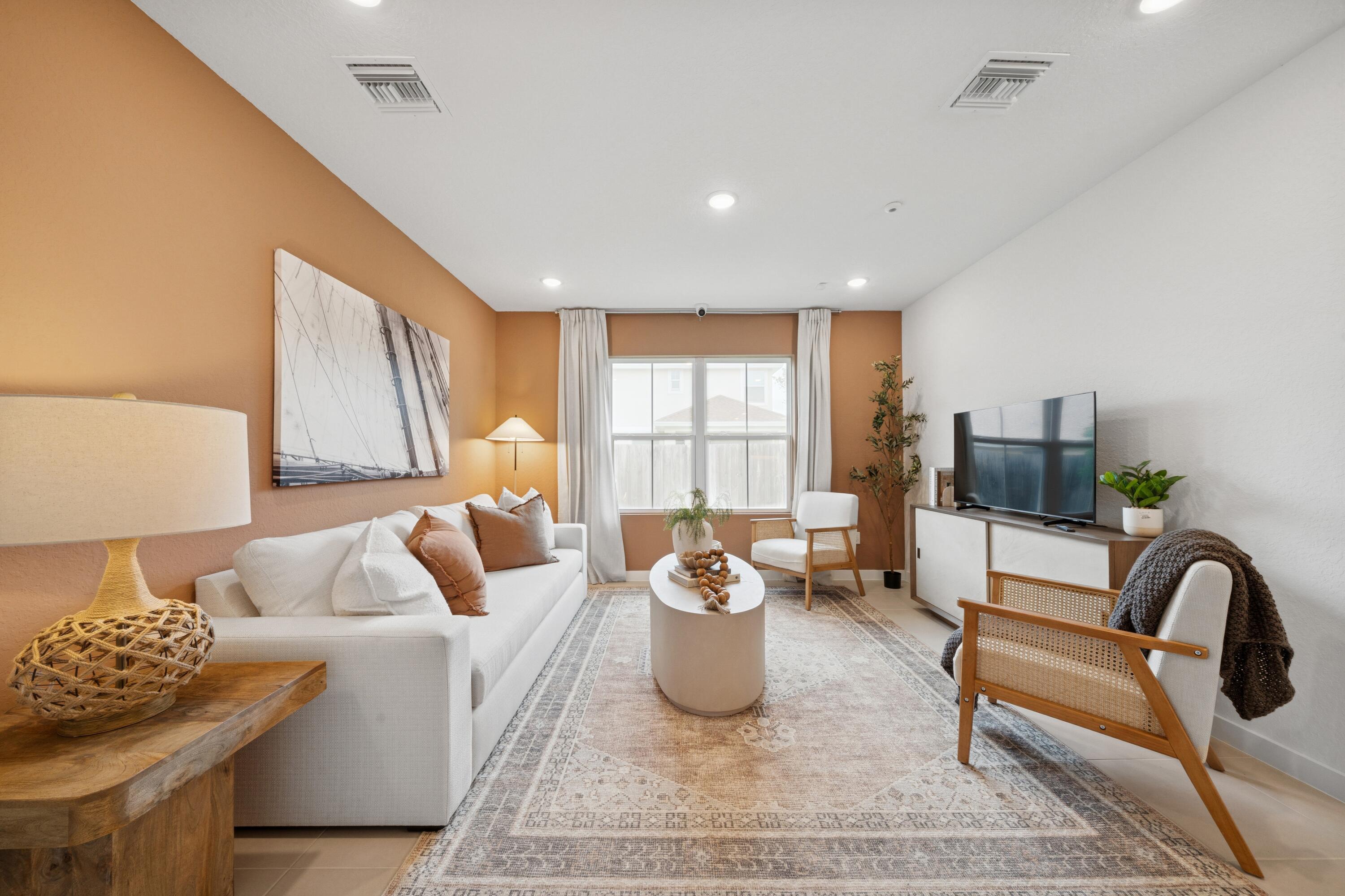 9744 Apollo Avenue, Unit 1 Fort Pierce, FL 34945 - Photo 27 of 39 a living room with furniture and a large window