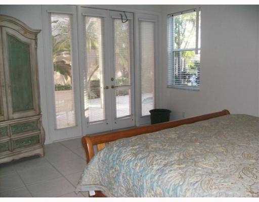 2488 Northwest 67th Street Boca Raton, FL 33496 - Photo 8 of 9 a bedroom with a large bed and a large window
