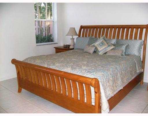 2488 Northwest 67th Street Boca Raton, FL 33496 - Photo 9 of 9 a bed sitting in a bedroom next to a window