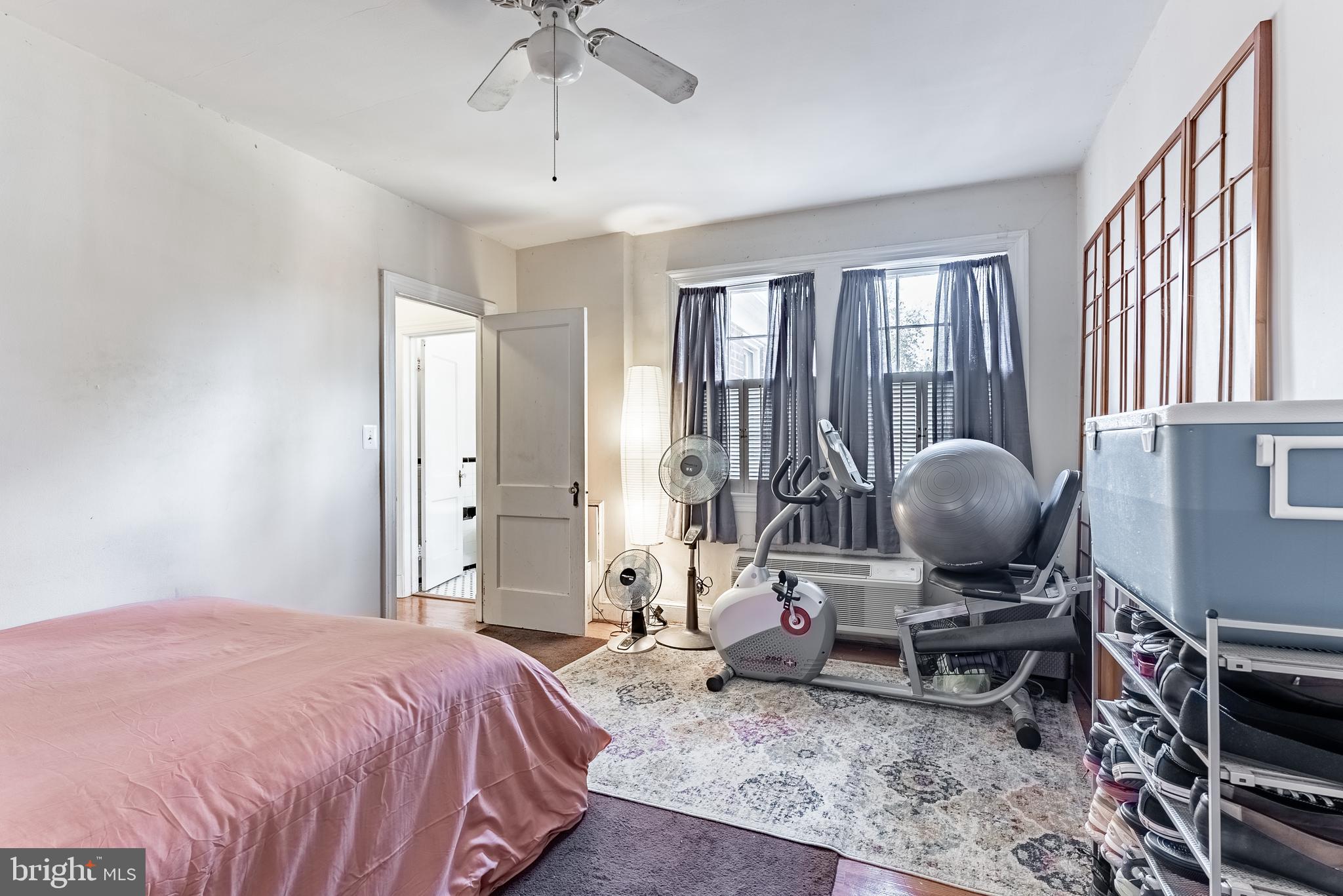 715 South Washington Street, Unit A16 Alexandria, VA 22314 - Photo 14 of 23 a bedroom with a bed and large windows