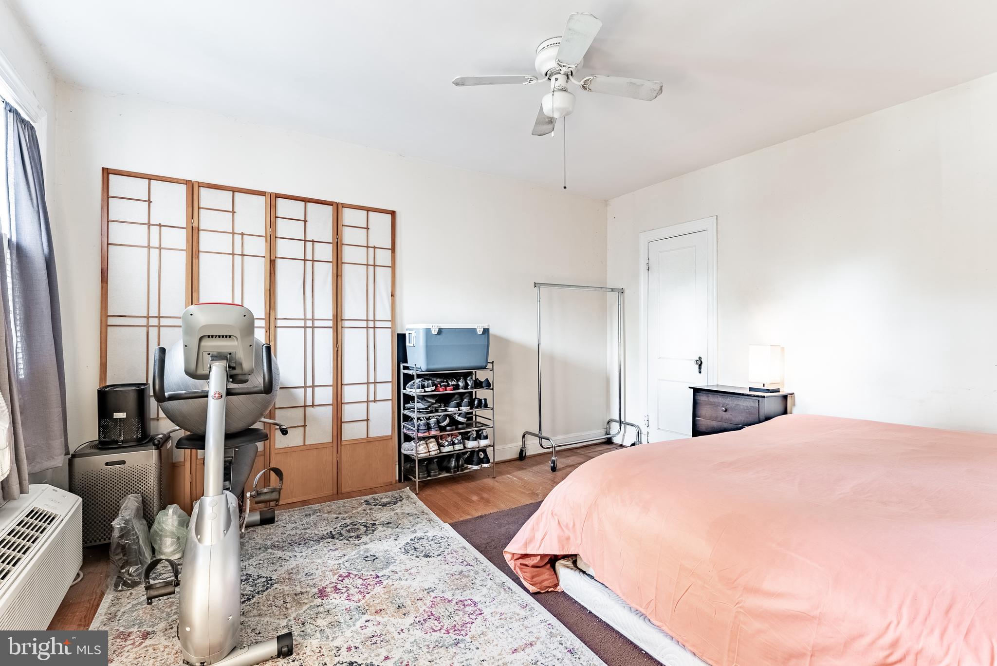 715 South Washington Street, Unit A16 Alexandria, VA 22314 - Photo 15 of 23 a bed room with a bed and wooden floor