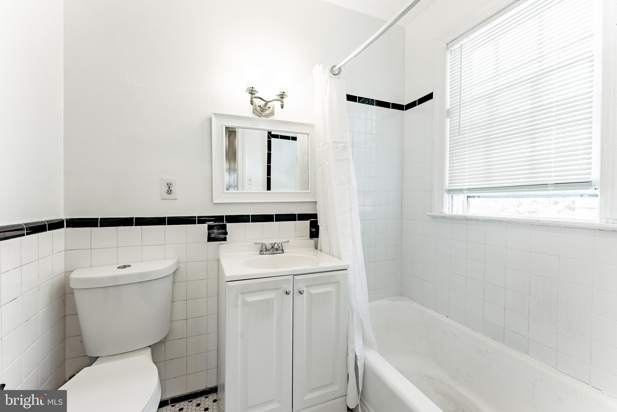 715 South Washington Street, Unit A16 Alexandria, VA 22314 - Photo 16 of 23 a bathroom with a sink a toilet and a bathtub