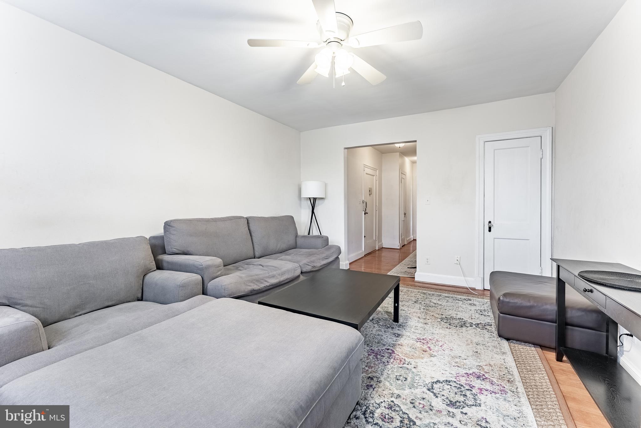 715 South Washington Street, Unit A16 Alexandria, VA 22314 - Photo 19 of 23 a living room with furniture and a rug