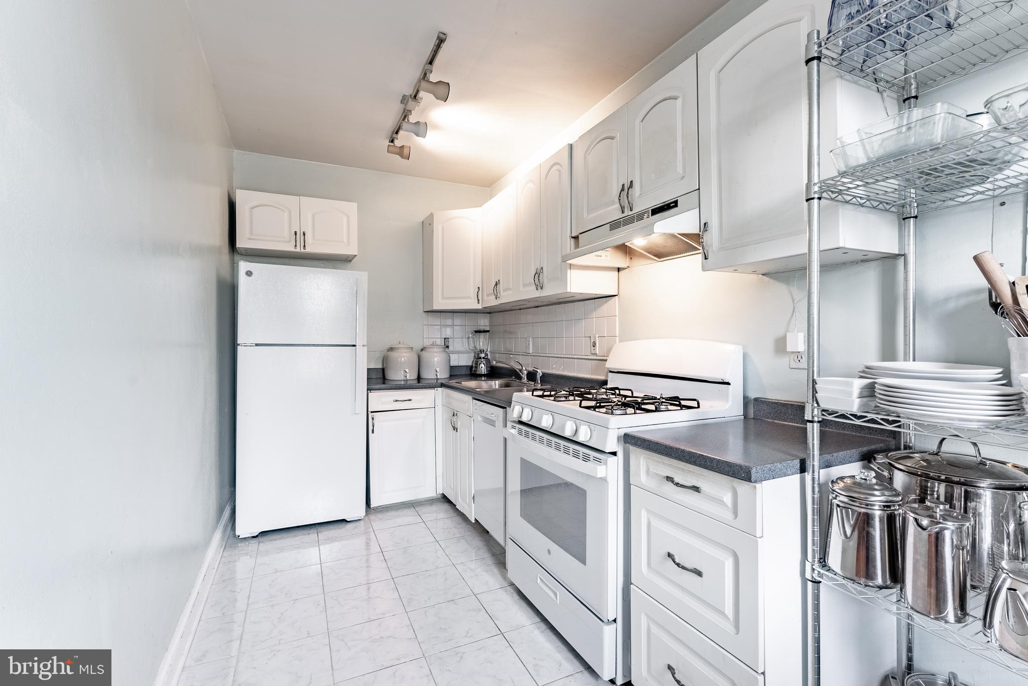 715 South Washington Street, Unit A16 Alexandria, VA 22314 - Photo 23 of 23 a kitchen with cabinets and a stove top oven