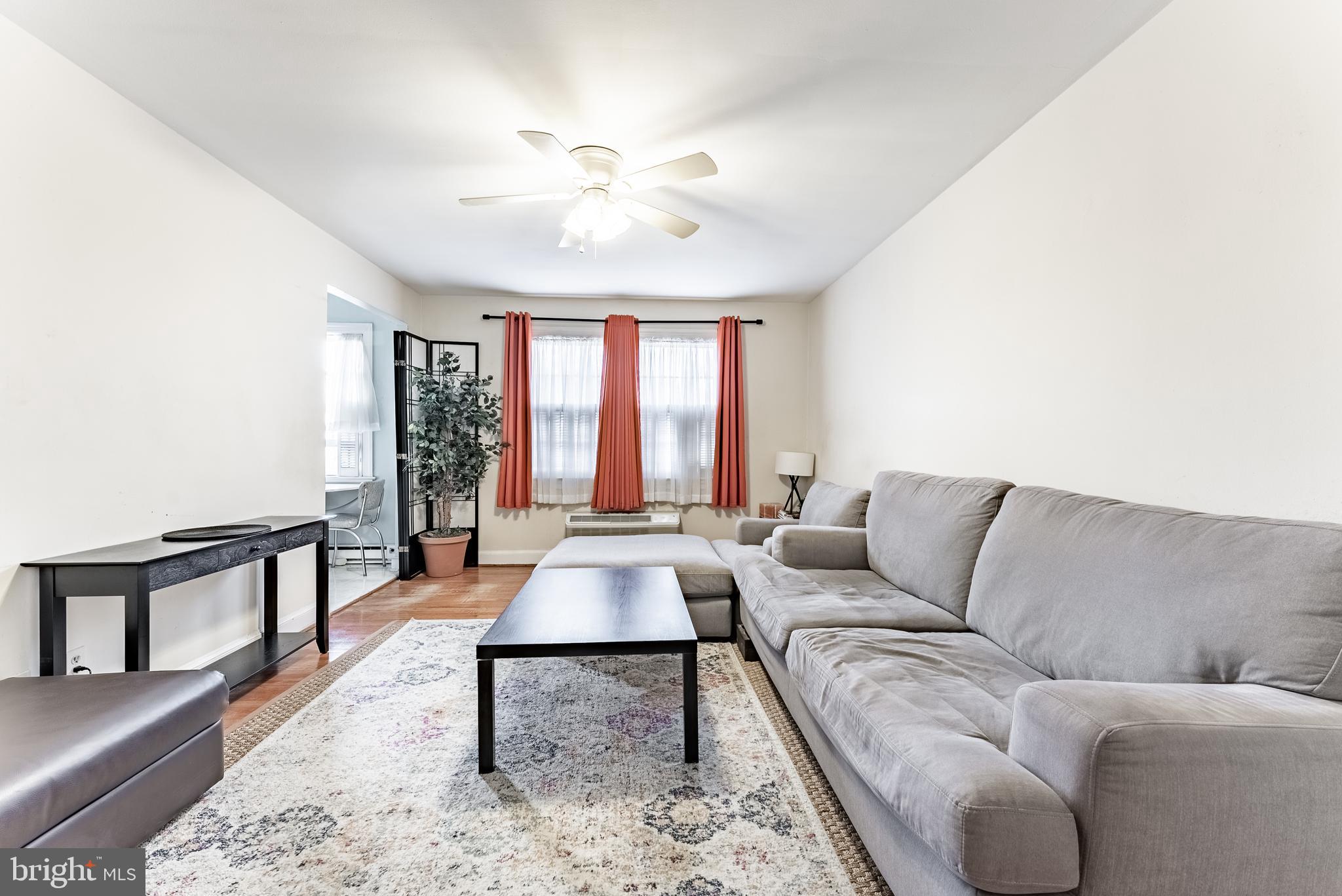 715 South Washington Street, Unit A16 Alexandria, VA 22314 - Photo 4 of 23 a living room with furniture and a large window