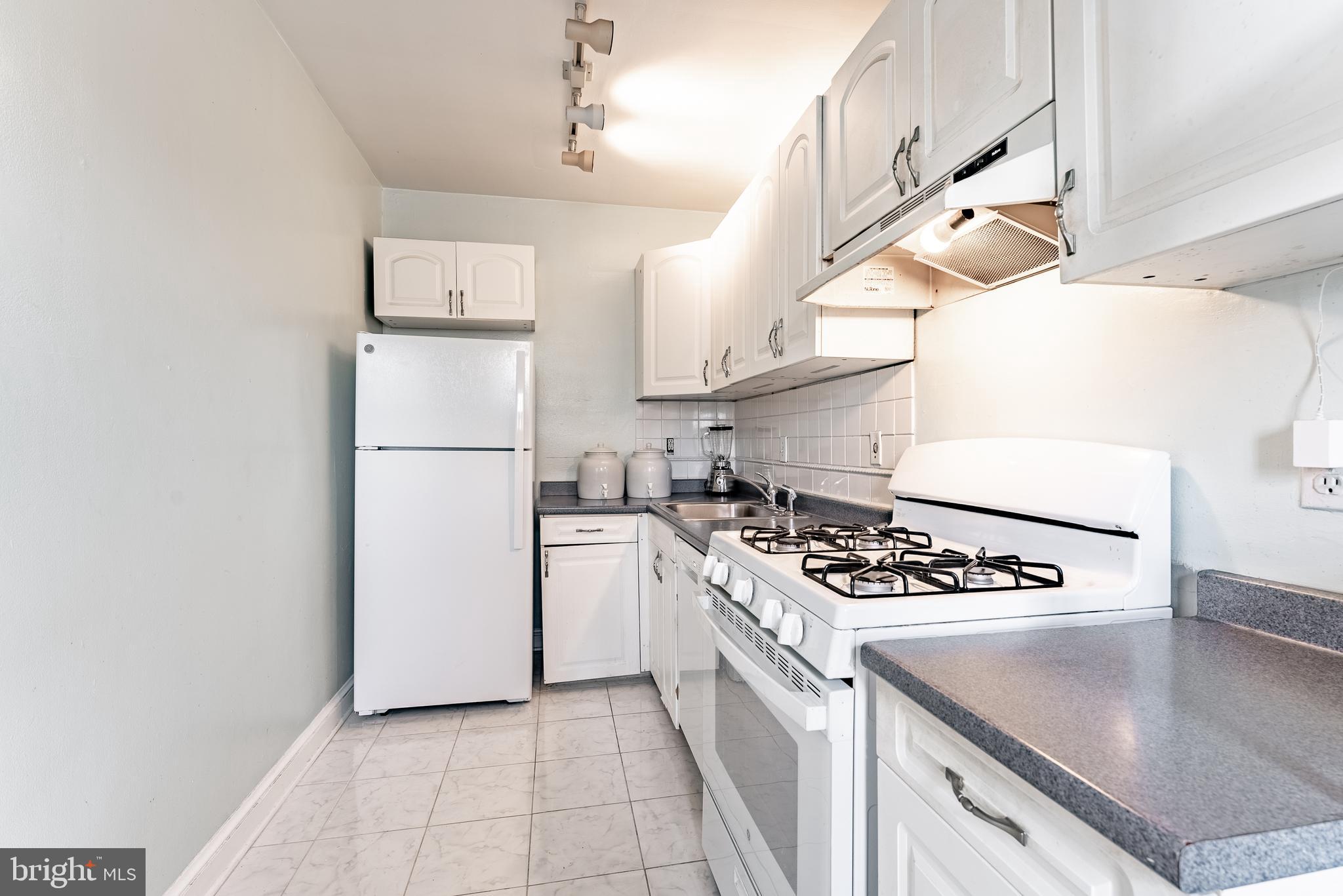 715 South Washington Street, Unit A16 Alexandria, VA 22314 - Photo 6 of 23 a kitchen with cabinets and appliances