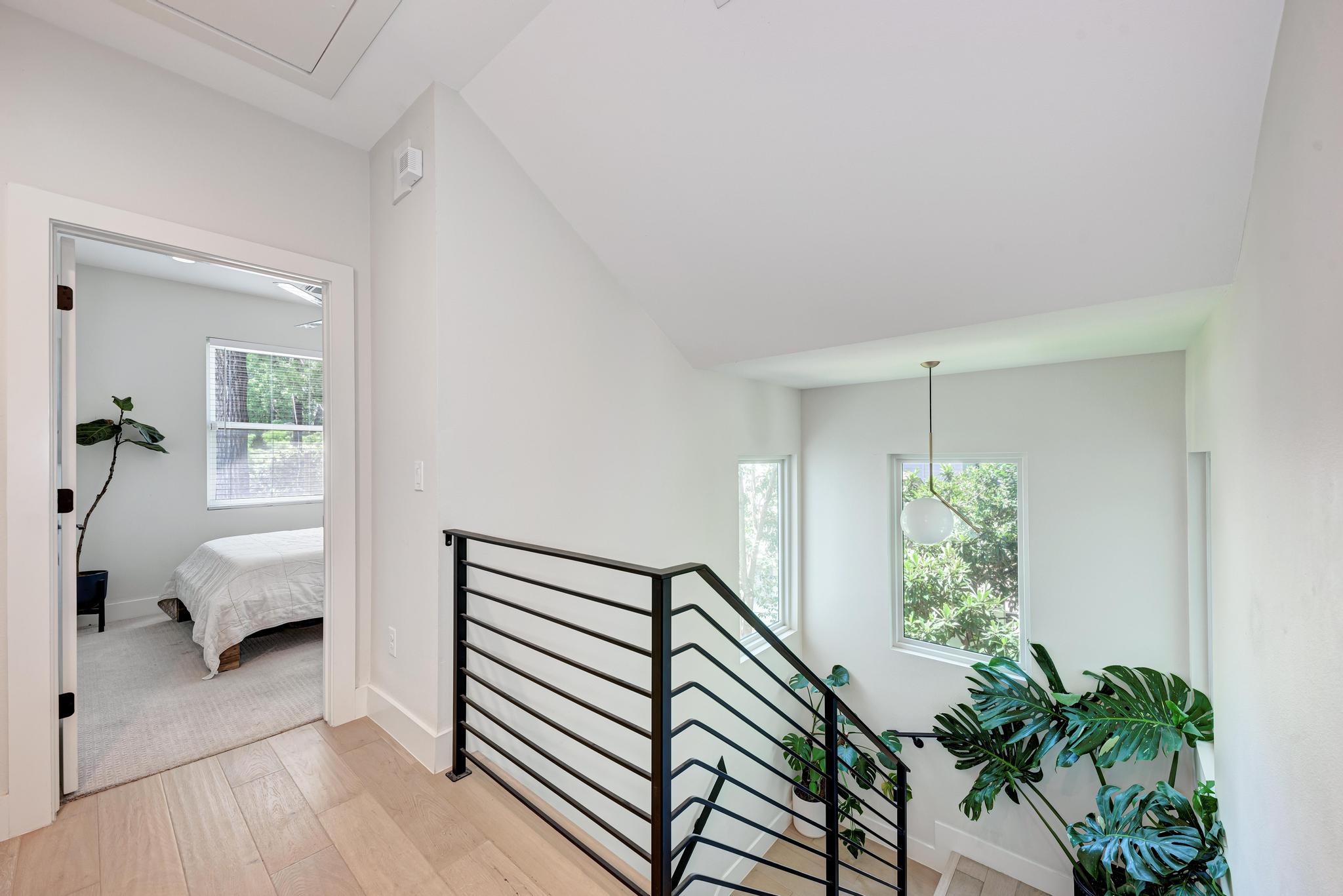 918 Cardinal Lane, Unit A Austin, TX 78704 - Photo 18 of 40 Sleek and modern wrought iron railings run up the stairs, which is bathed in natural light during the day.
