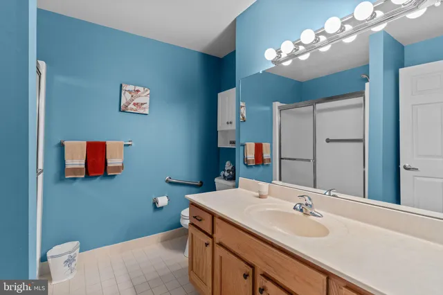 a bathroom with a sink a light fixture and a mirror